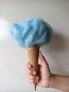 Person Holding Blue Cotton Ball