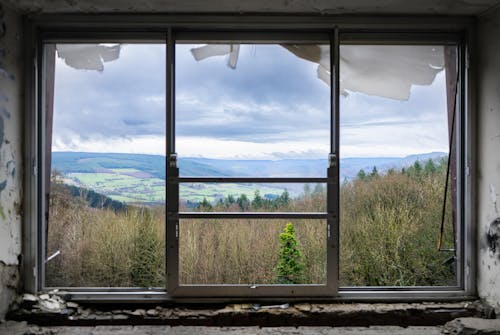  Rolling Landscape Seen Through a Broken Window in Abandoned House