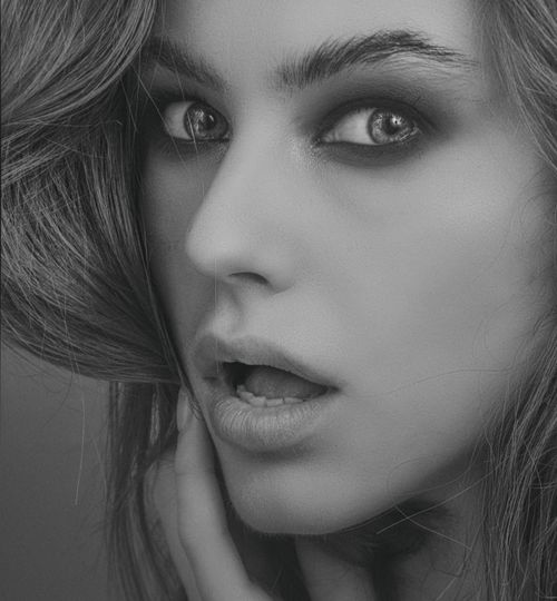 Free Close-up monochrome portrait capturing a woman's shocked expression. Stock Photo