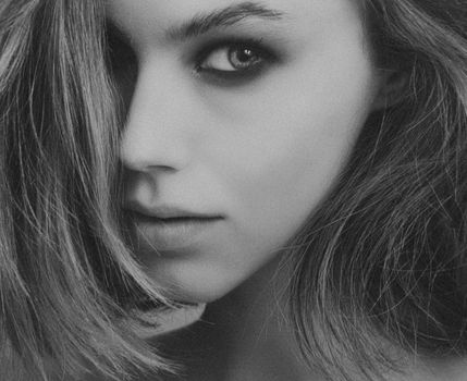 Stunning black and white close-up portrait of a woman with captivating eyes.
