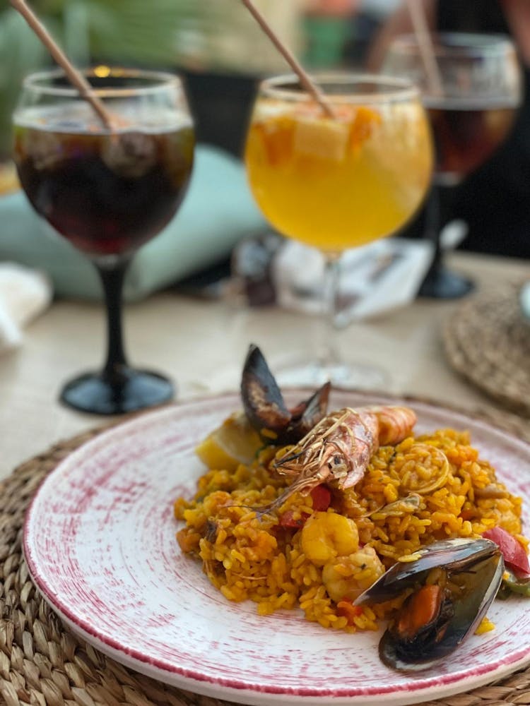 Rice With Shrimp And Mussel On A Red And White Plate