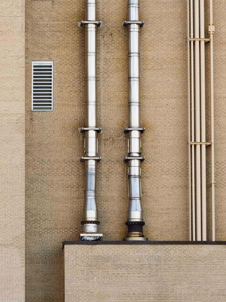 Stainless Pipes On Exterior Wall Of A Building