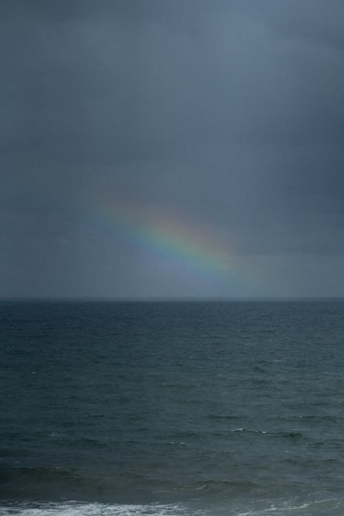 Free A Rainbow over a Seascape Stock Photo