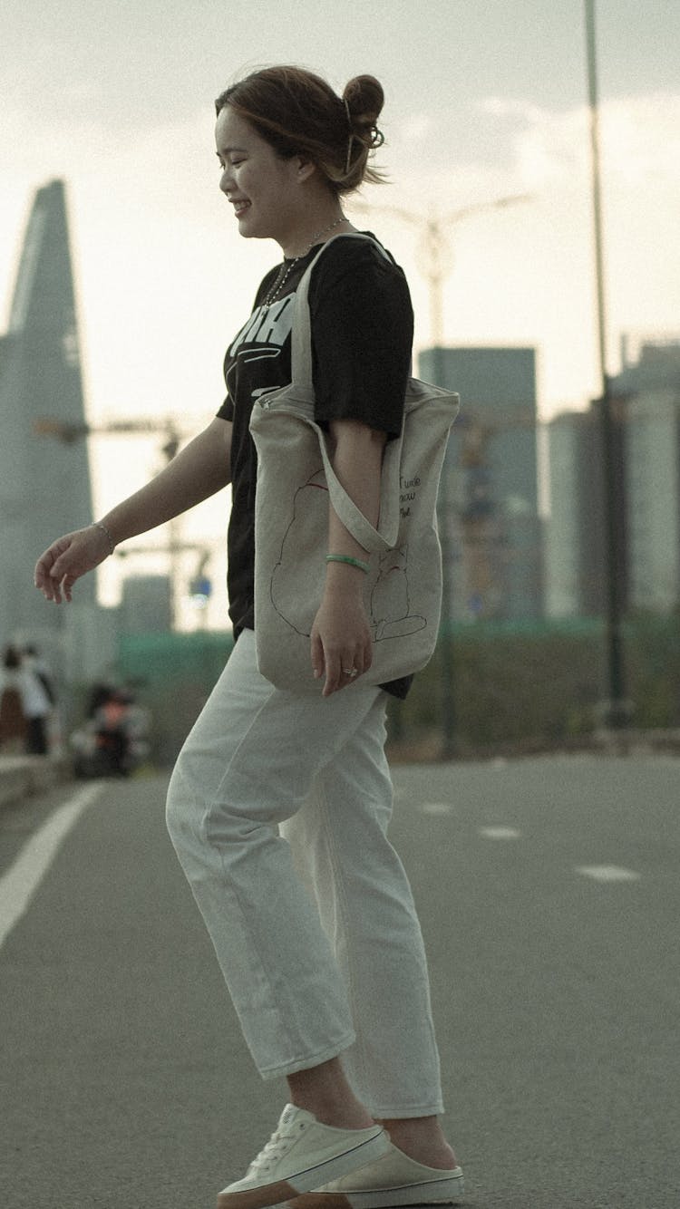 Woman On Empty Street In City