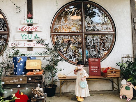 A child in front of a Christmas decorated store in Chiang Mai, Thailand.