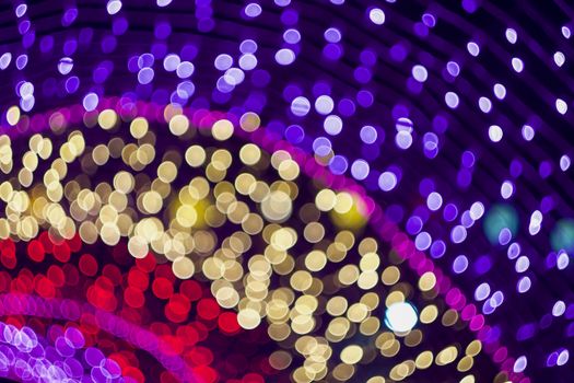 Colorful bokeh lights forming abstract festive patterns, ideal for holiday celebrations.