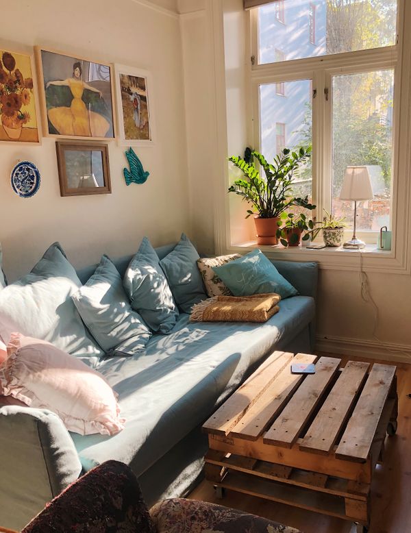 A living room with a blue sofa — Merve Bayar on Pexels