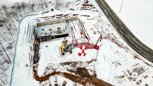 A Crane Equipment at a Construction Site on  Snow Covered Ground