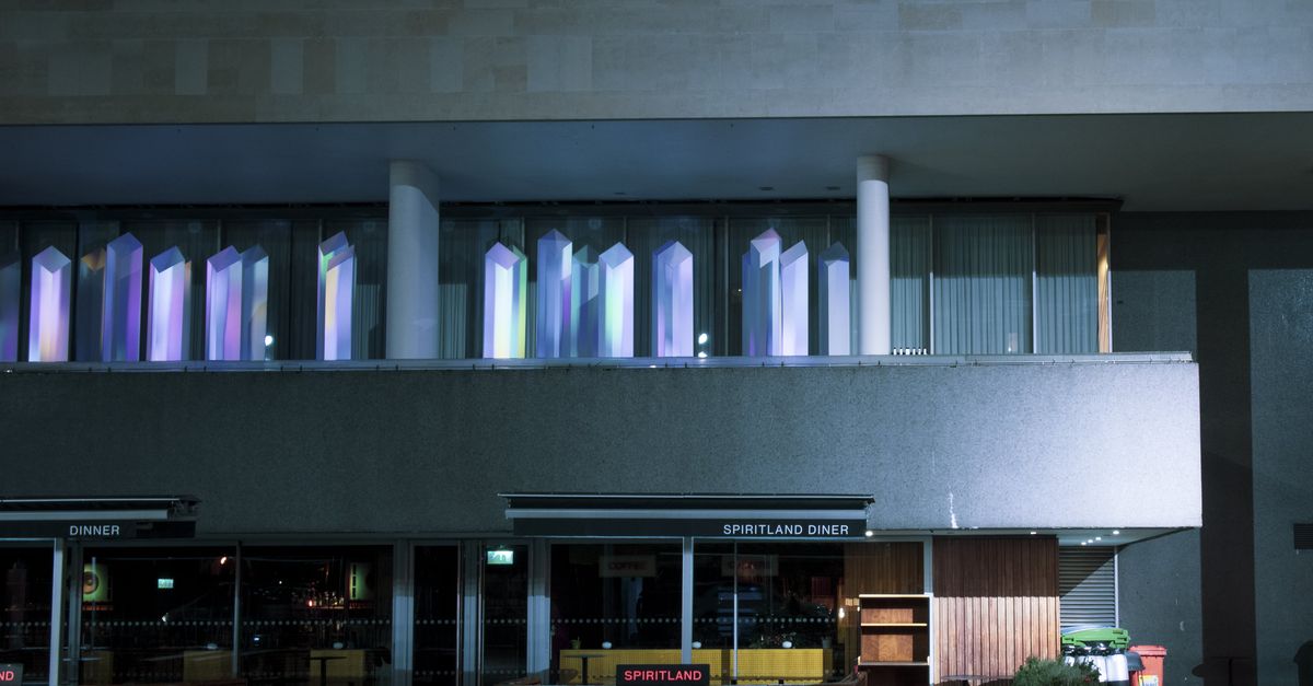 A night view of Spiritland Diner in London with colorful window illuminations.