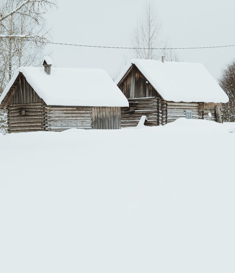 Wooden Cabins Covered In Snow 