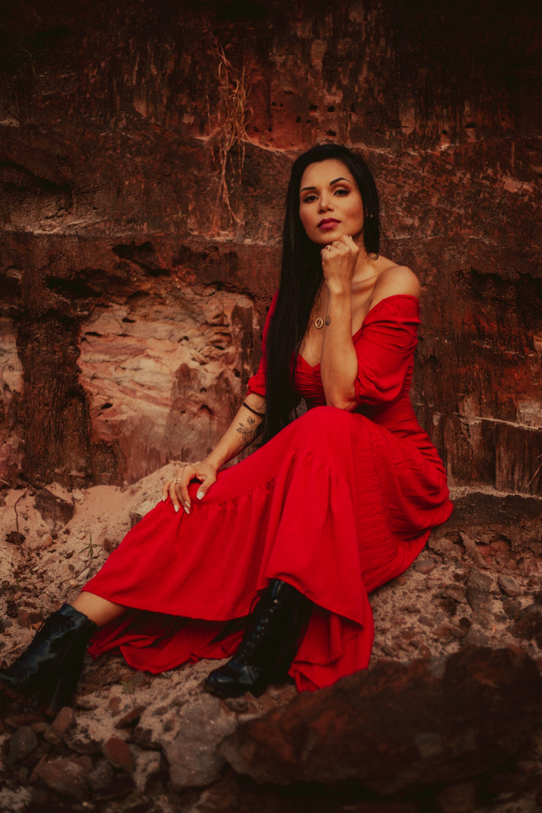 Woman in a Red Dress Sitting on a Rock · Free Stock Photo