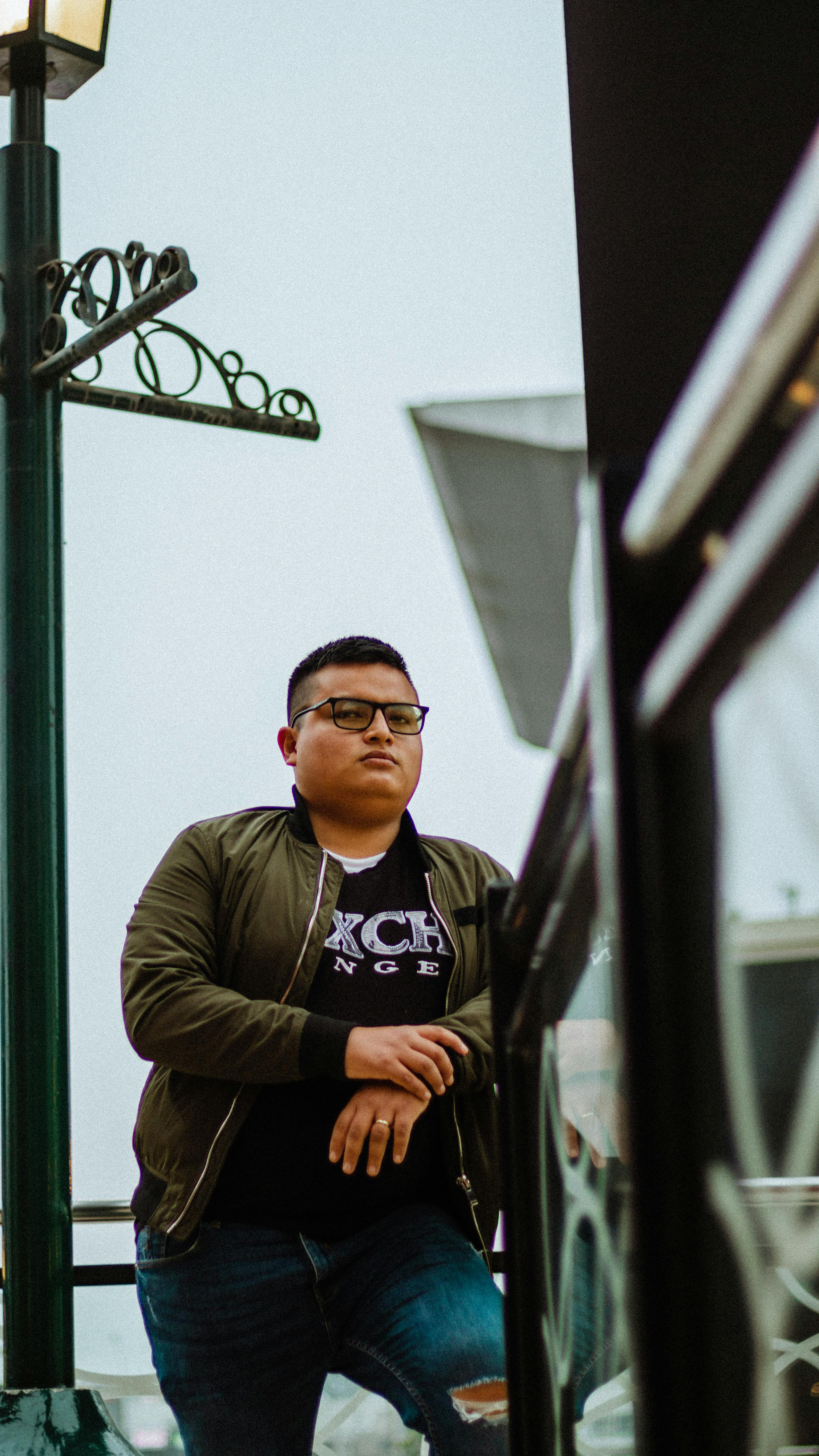 Portrait of a stylish man standing outdoors in Lima, Peru with vibrant background.