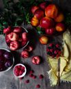 Plums, Raspberries, Nectarines in Bowls on Table