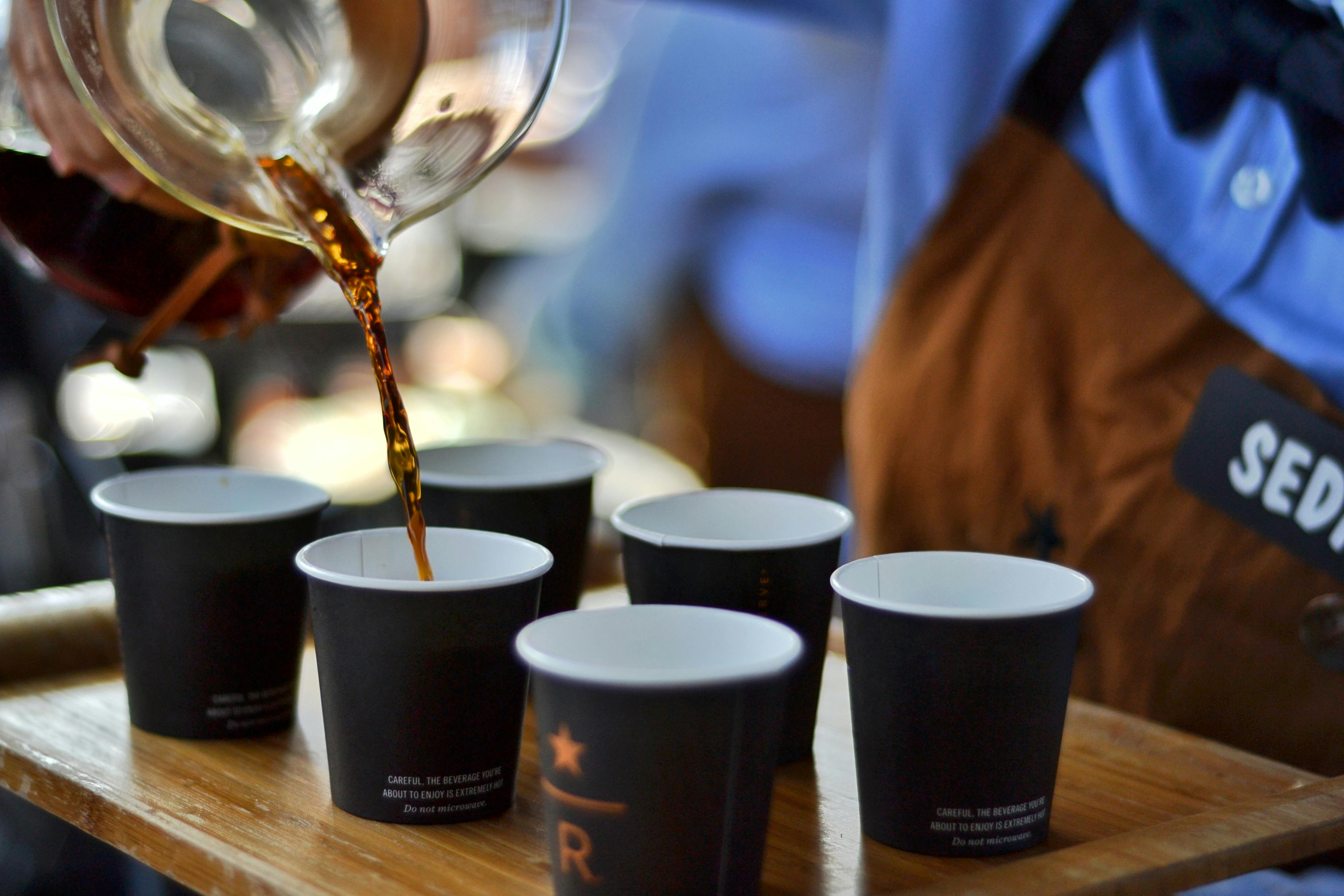Pouring of Coffee Drinks into Disposable Cups · Free Stock Photo