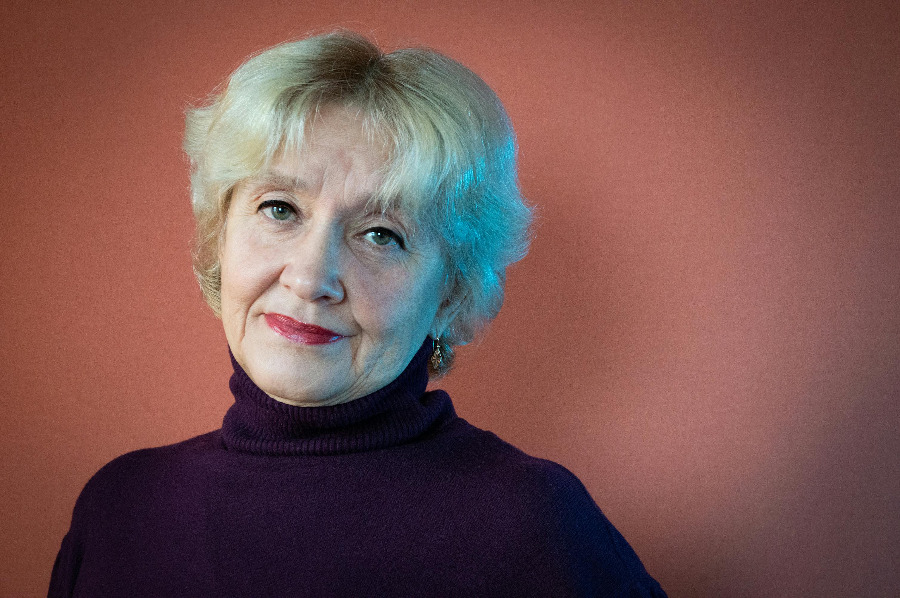 Portrait of a senior woman with elegant expression, captured in a studio setting.