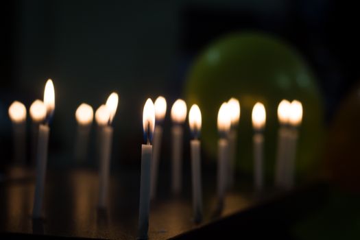 Softly glowing candles create a warm atmosphere in a dimly lit room.