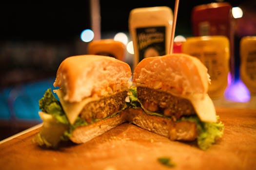 Close-up of a delicious cheeseburger with lettuce and sauce, perfect for fast food lovers.