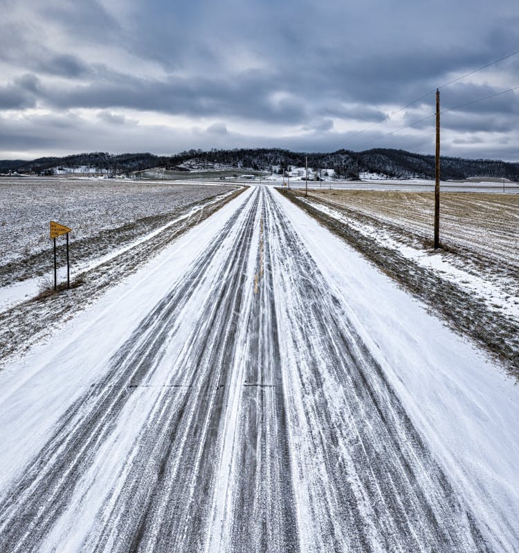 Snow Covered Road Near The Mountain