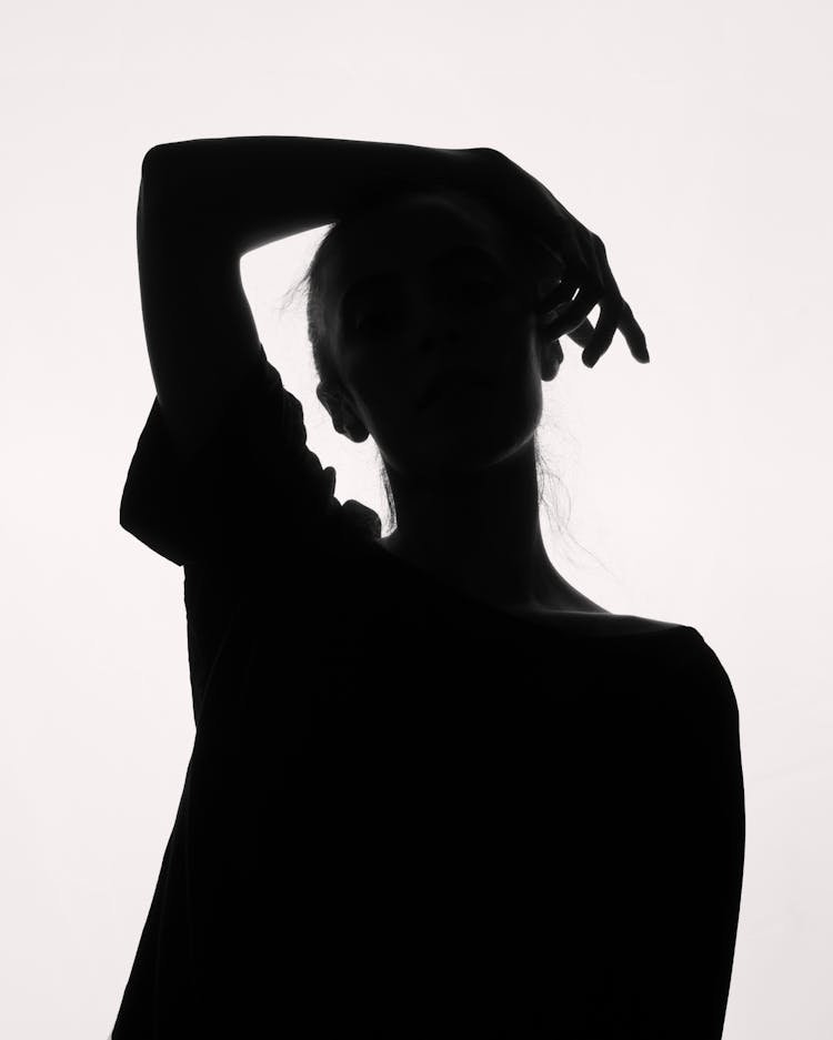 Silhouette Of A Girl With Hand On Head