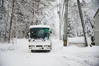 White and Green Bus on Snow Covered Road