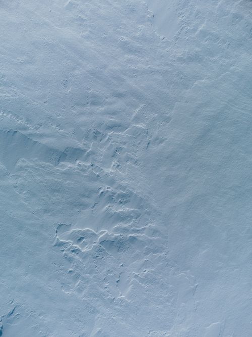 Free A high-angle view of textured and snowy landscape, offering a unique abstract pattern. Stock Photo