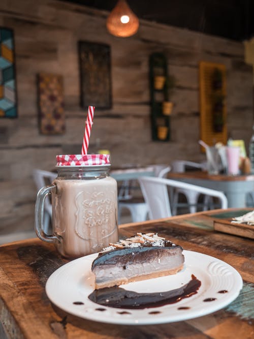 A Delicious Drink Beside a Slice of Cake