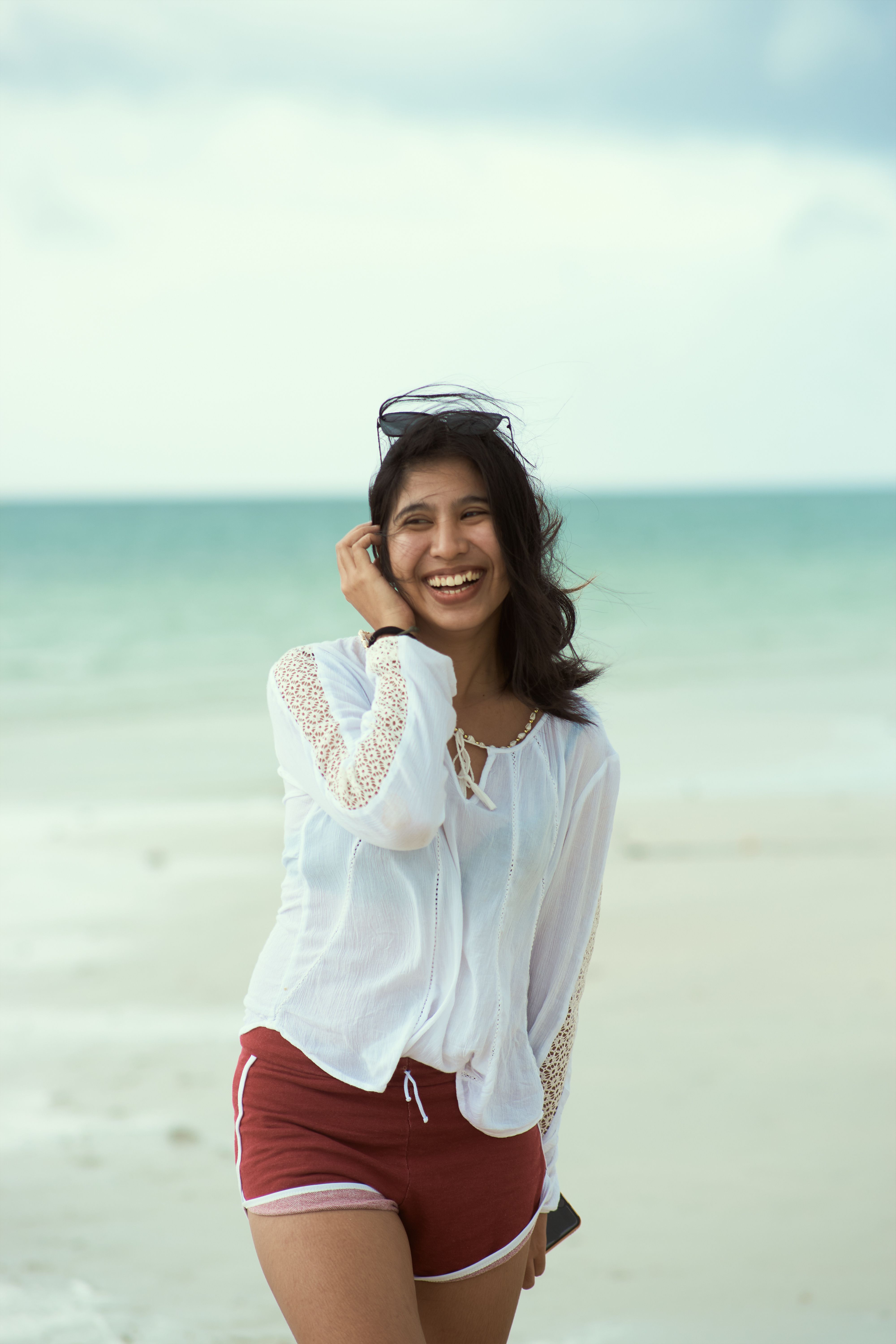 Woman Wearing White Long Sleeves on Beach Shore · Free Stock Photo