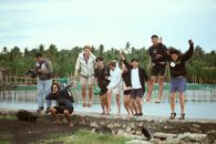 Group of People on a Concrete Gutter
