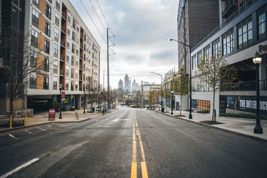 Urban street with view of downtown Atlanta skyline, capturing city's architectural charm.