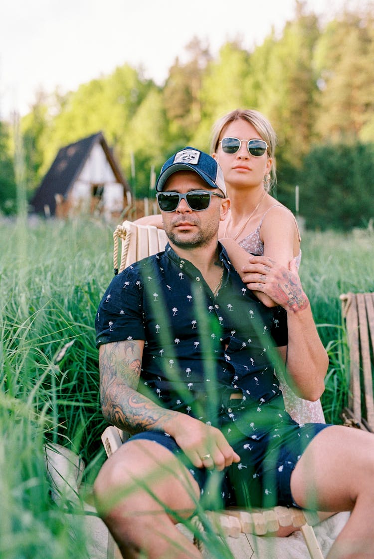 Couple Relaxing On A Meadow Near Forrest