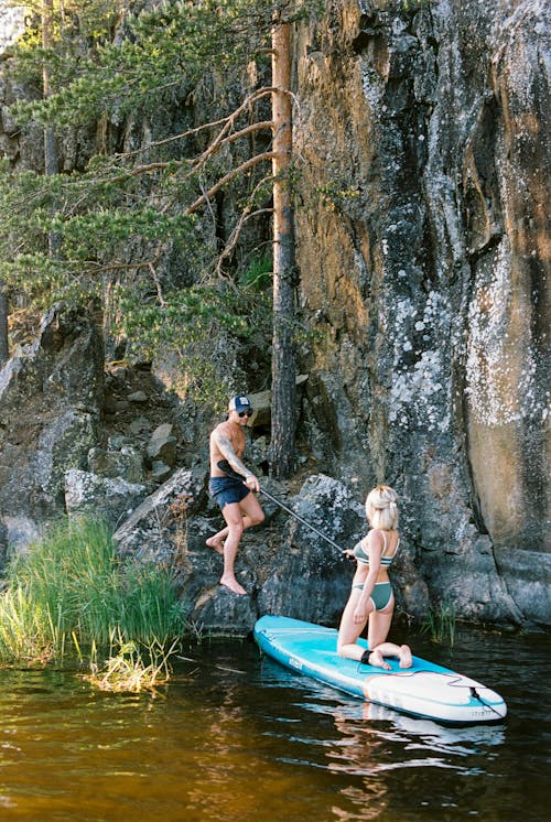 Man and Woman Holding a Boat Paddle