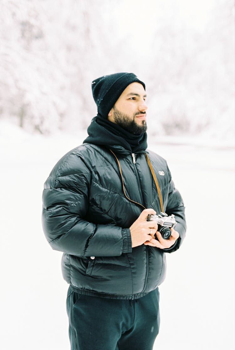 Portrait Of Young Man With Winter Forrest In The Background