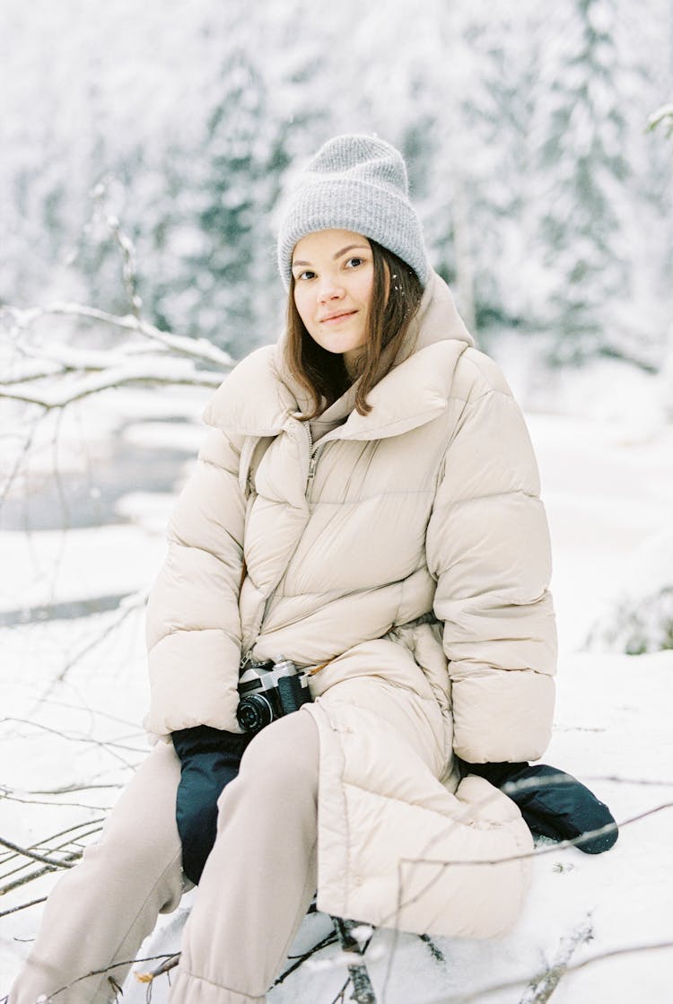 Portrait Of Young Woman Sitting With Winter Forrest In The Background