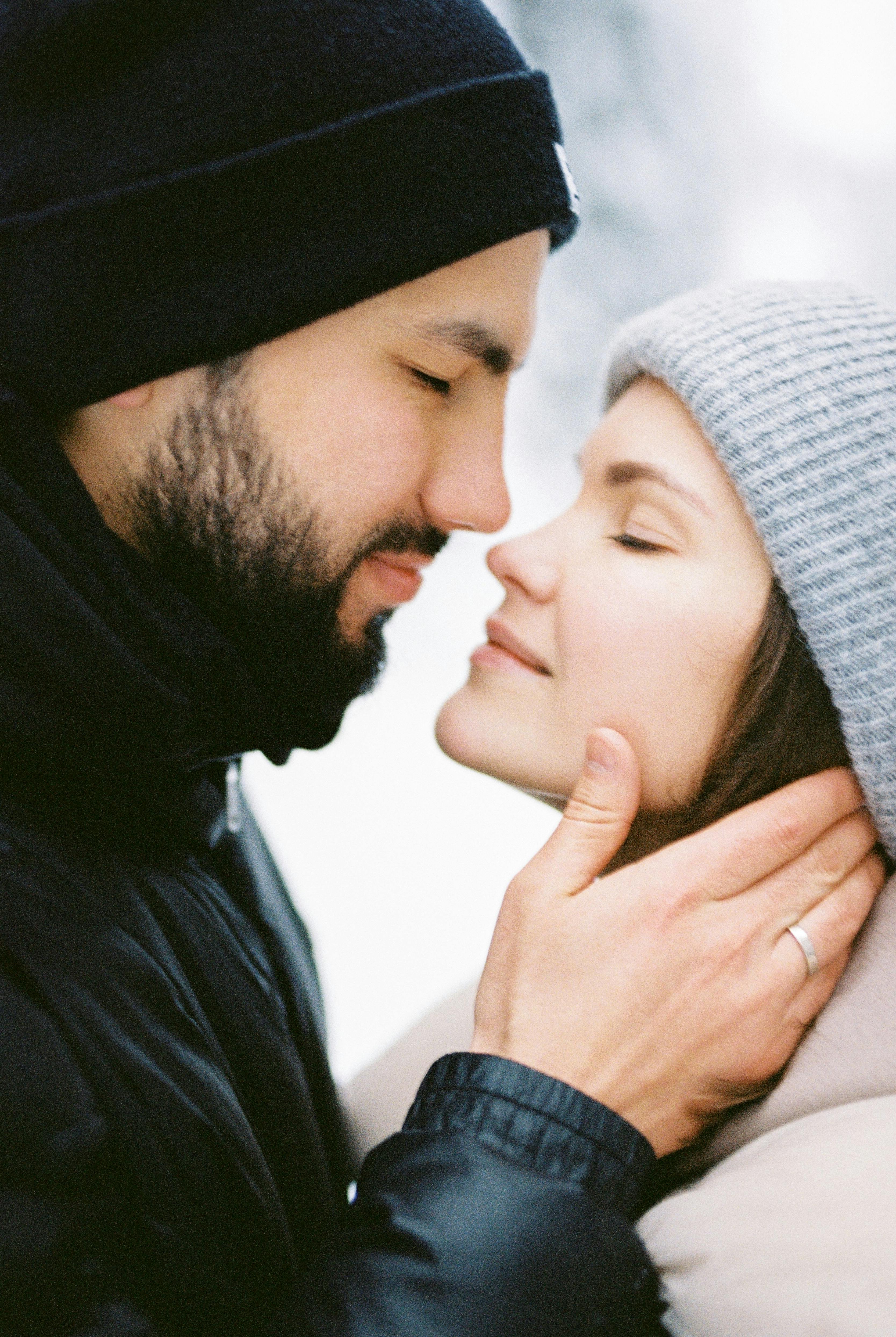 A romantic winter moment shared between a couple, highlighting intimacy and warmth.