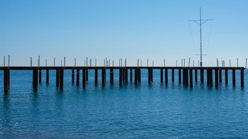 A Pier on Blue Water Under Blue Sky
