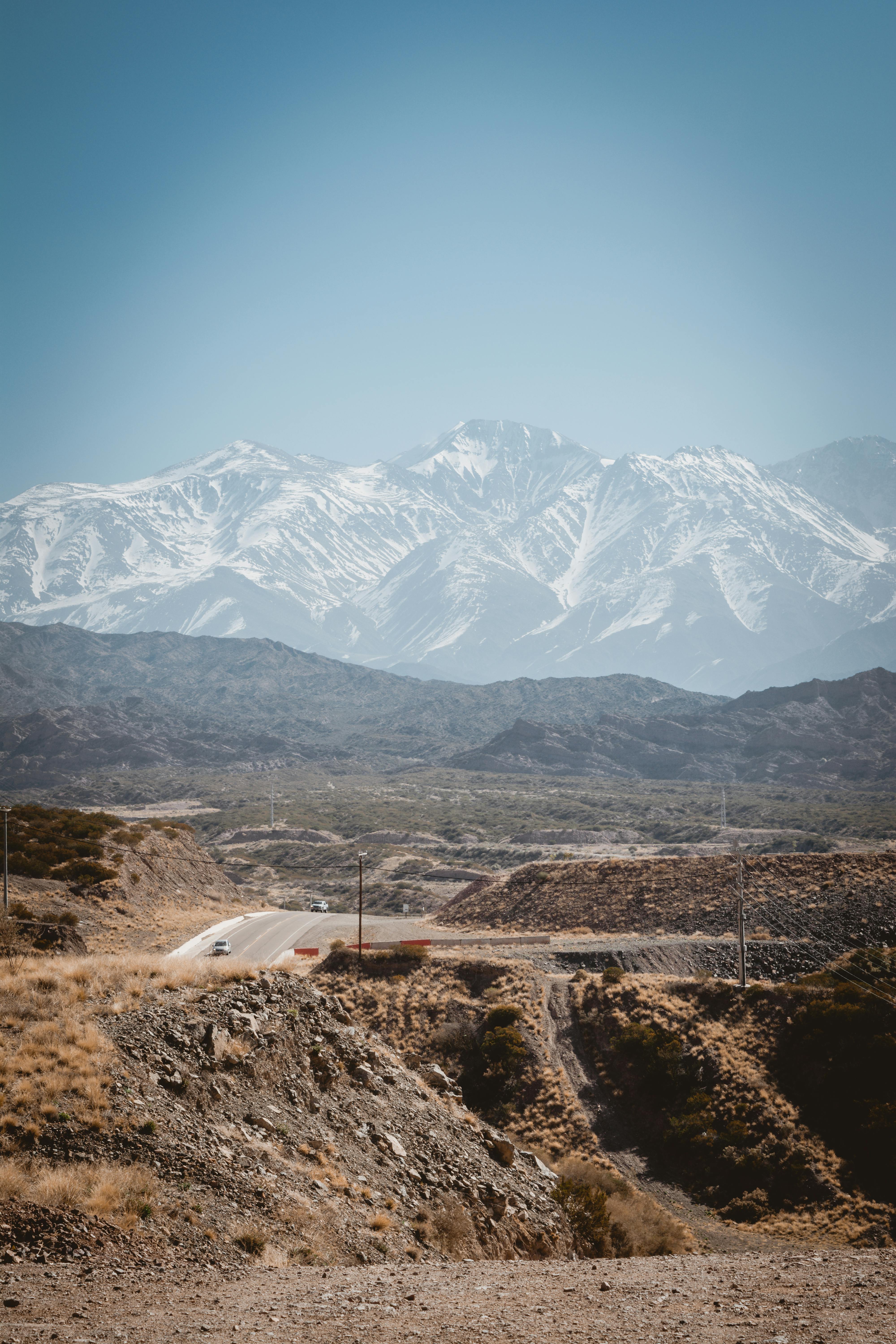 Beautiful view of the snow-capped Andes Mountains in Mendoza, Argentina under a clear blue sky.