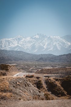 Beautiful view of the snow-capped Andes Mountains in Mendoza, Argentina under a clear blue sky.