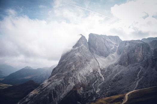 Stunning view of rocky mountain peaks enveloped in clouds, showcasing nature's grandeur.