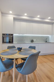 Sleek Scandinavian-style kitchen with wooden elements and minimalistic decor in a modern apartment.