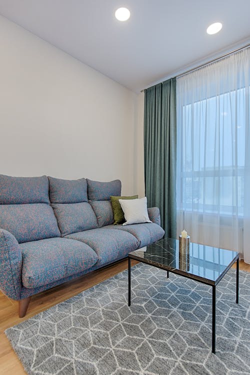 Gray Sofa Near Window Curtain