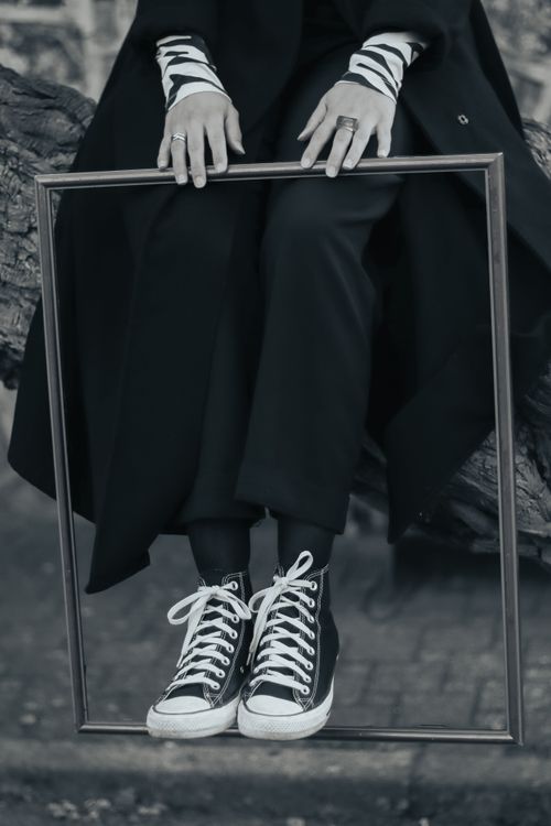 Free Black and white shot featuring sneakers and a picture frame, highlighting urban style fashion. Stock Photo