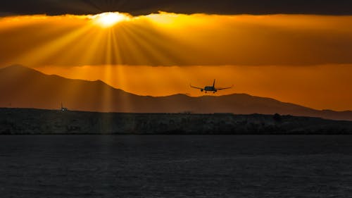 Free Silhouette of Airplane over Body of Water Stock Photo