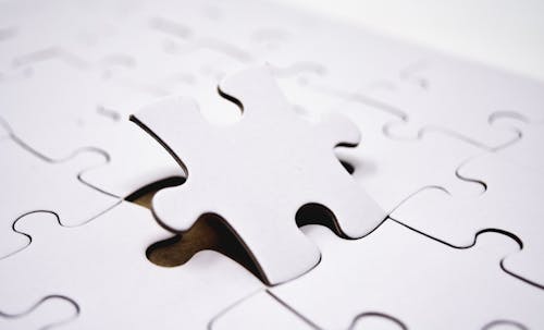 Close-Up Shot of White Jigsaw Puzzle