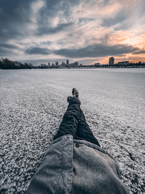 Person sitting on a Snow Covered Ground 