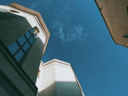 Free A modern building exterior in Moscow under a clear blue sky captured from a low angle. Stock Photo