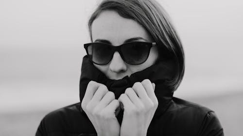 A Grayscale Photo of a Woman Wearing Sunglasses