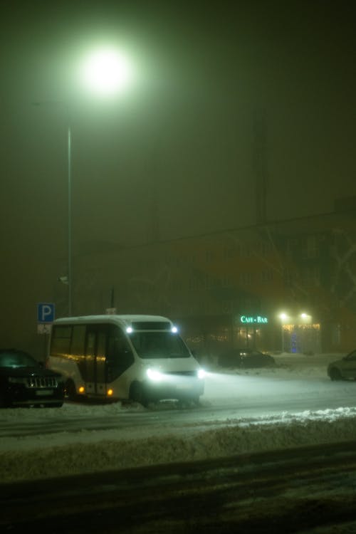 Cars Parked on a Snow Covered Ground at Night