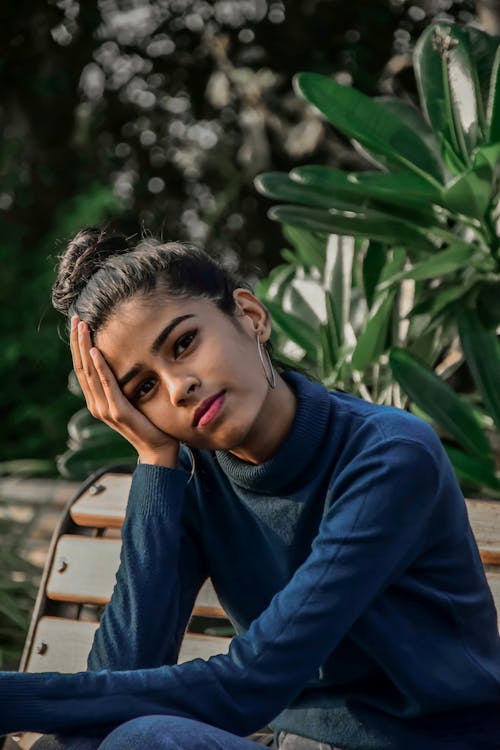 A Woman in Blue Long Sleeve Shirt Looking at the Camera