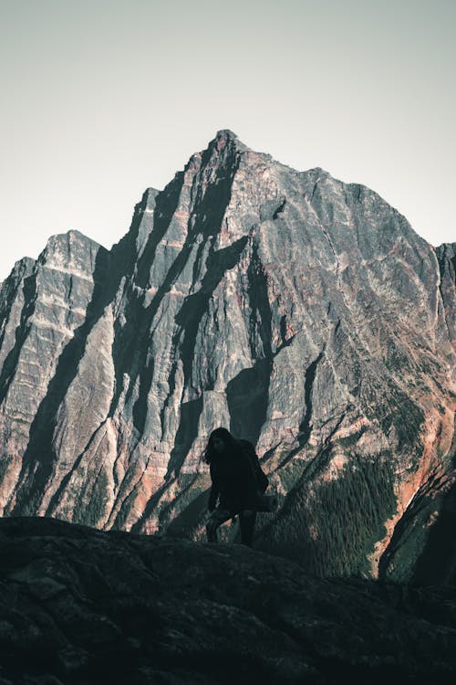 Person Standing on Rock Formation