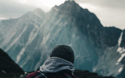 Free Person in warm attire gazing at stunning mountain view in British Columbia, Canada. Stock Photo